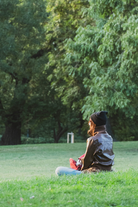 A woman sits in a park outside in Florence, KY, relaxing