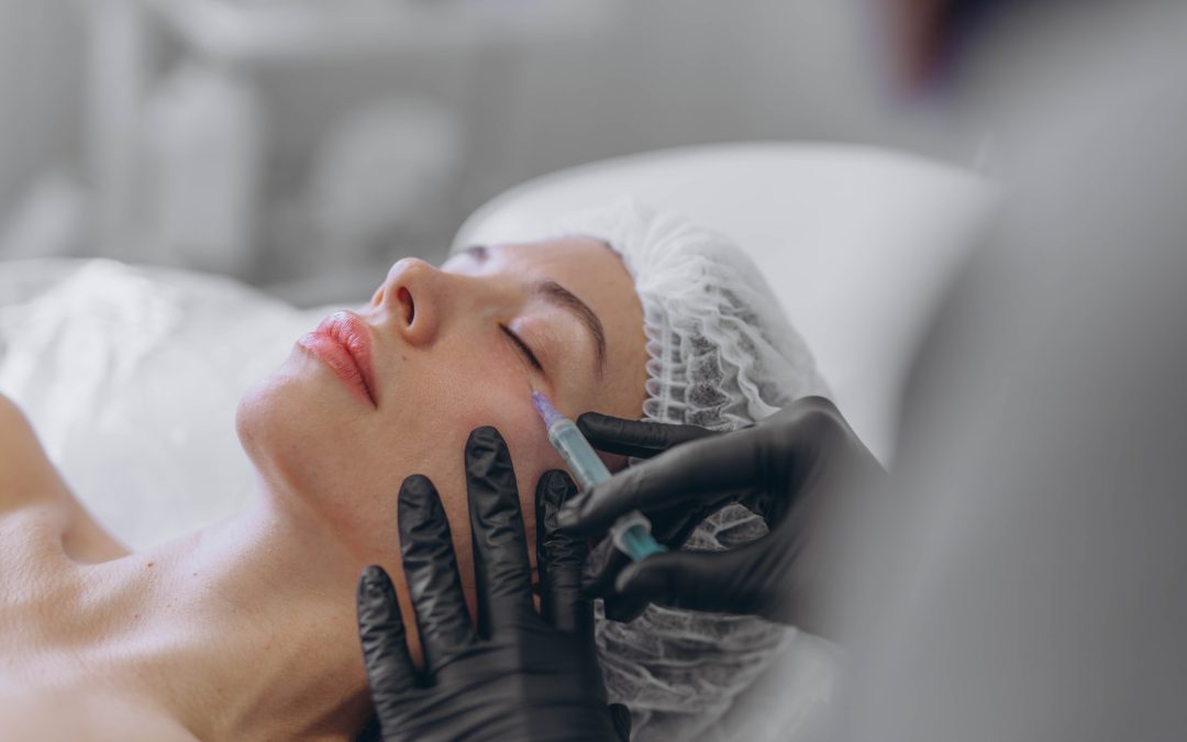 woman getting a botox injection from doctor in black gloves